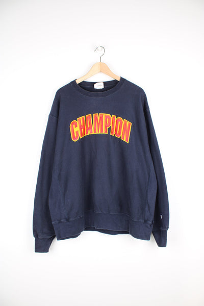 Vintage Champion reverse weave navy blue crewneck sweatshirt with embroidered spell-out logo across the chest