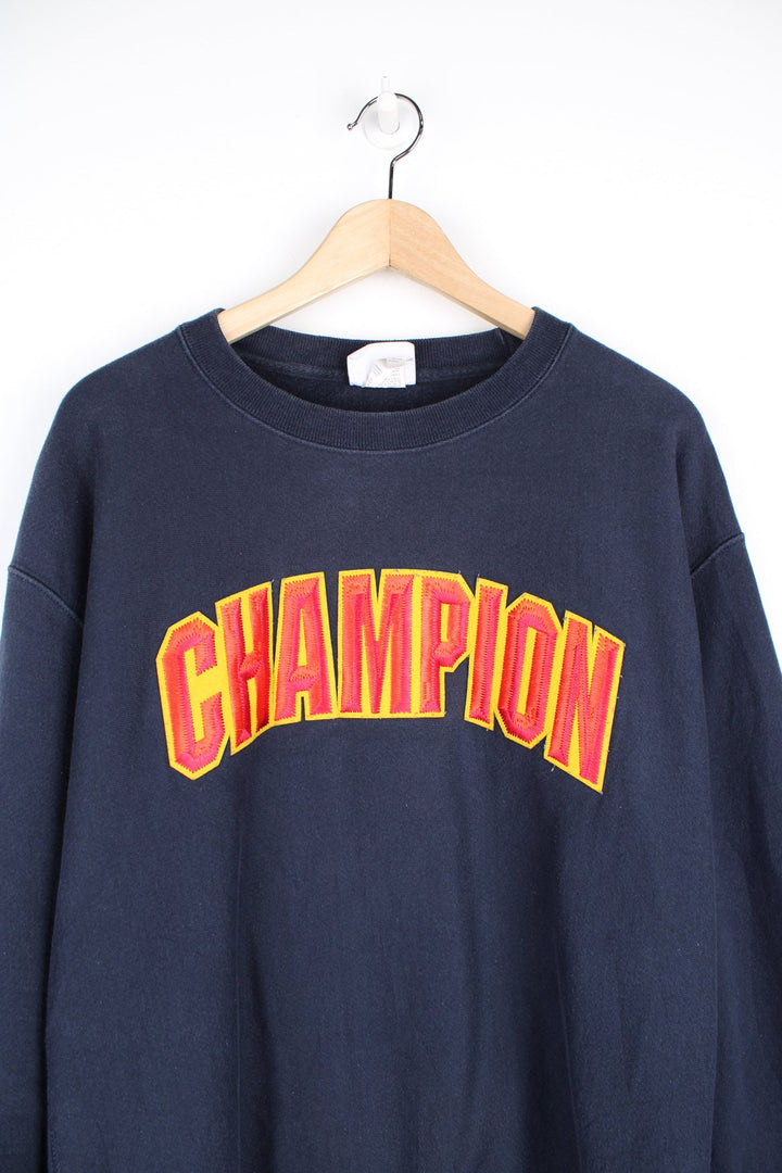 Vintage Champion reverse weave navy blue crewneck sweatshirt with embroidered spell-out logo across the chest