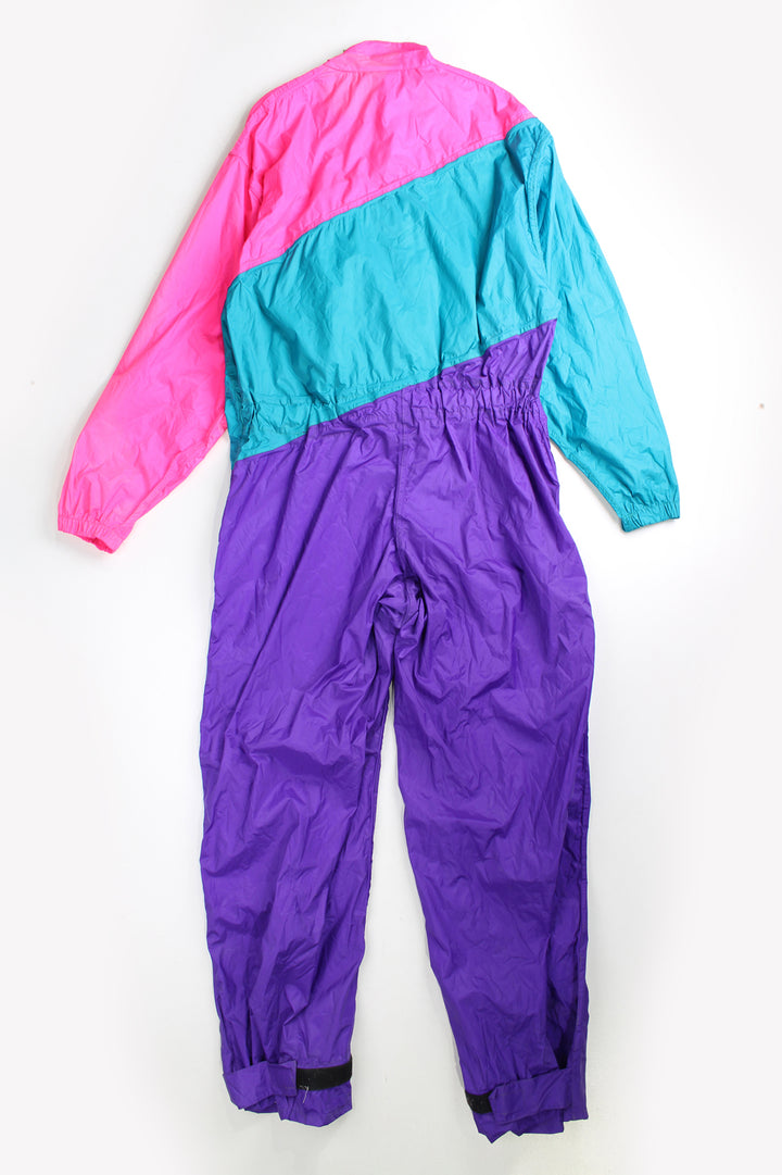 Vintage 80's Belstaff Dri Bika fold away waterproof coveralls. Pink and purple jumpsuit that folds away into a bag. Due to age the effectiveness of the waterproof fabric might be less. good condition - small mark on the front, scratches to the inside lining and some external scuffs Size in Label: Size L