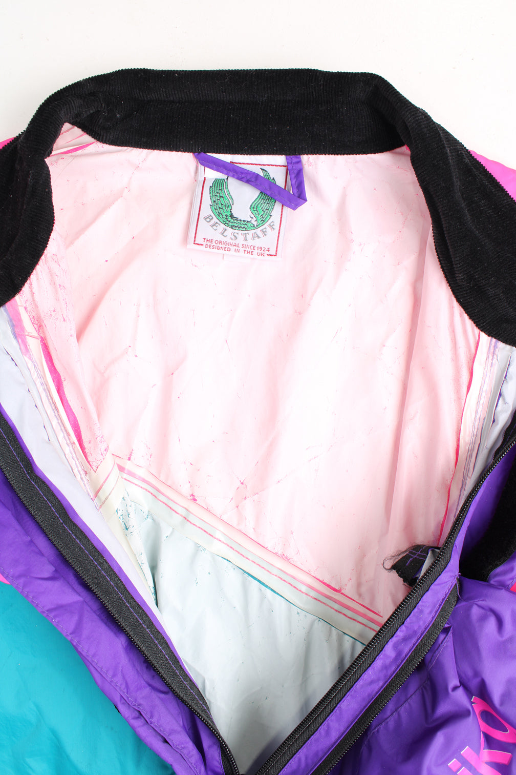 Vintage 80's Belstaff Dri Bika fold away waterproof coveralls. Pink and purple jumpsuit that folds away into a bag. Due to age the effectiveness of the waterproof fabric might be less. good condition - small mark on the front, scratches to the inside lining and some external scuffs Size in Label: Size L