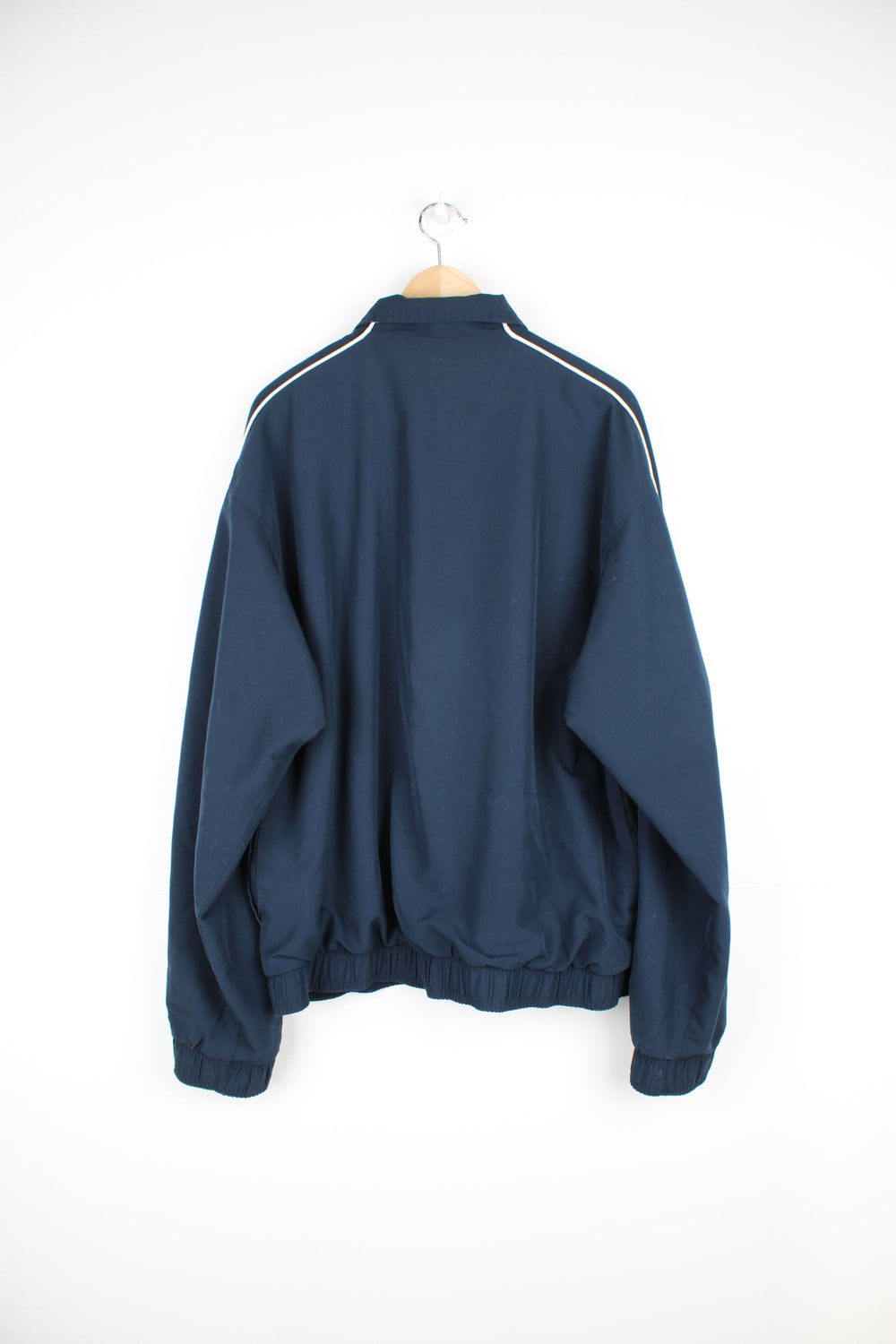 Vintage navy blue Reebok zip through track jacket with embroidered logo on the chest and spell-out down the sleeve