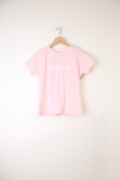 Y2K style pale pink baby tee by Reebok, features embroidered spell-out logo across the chest