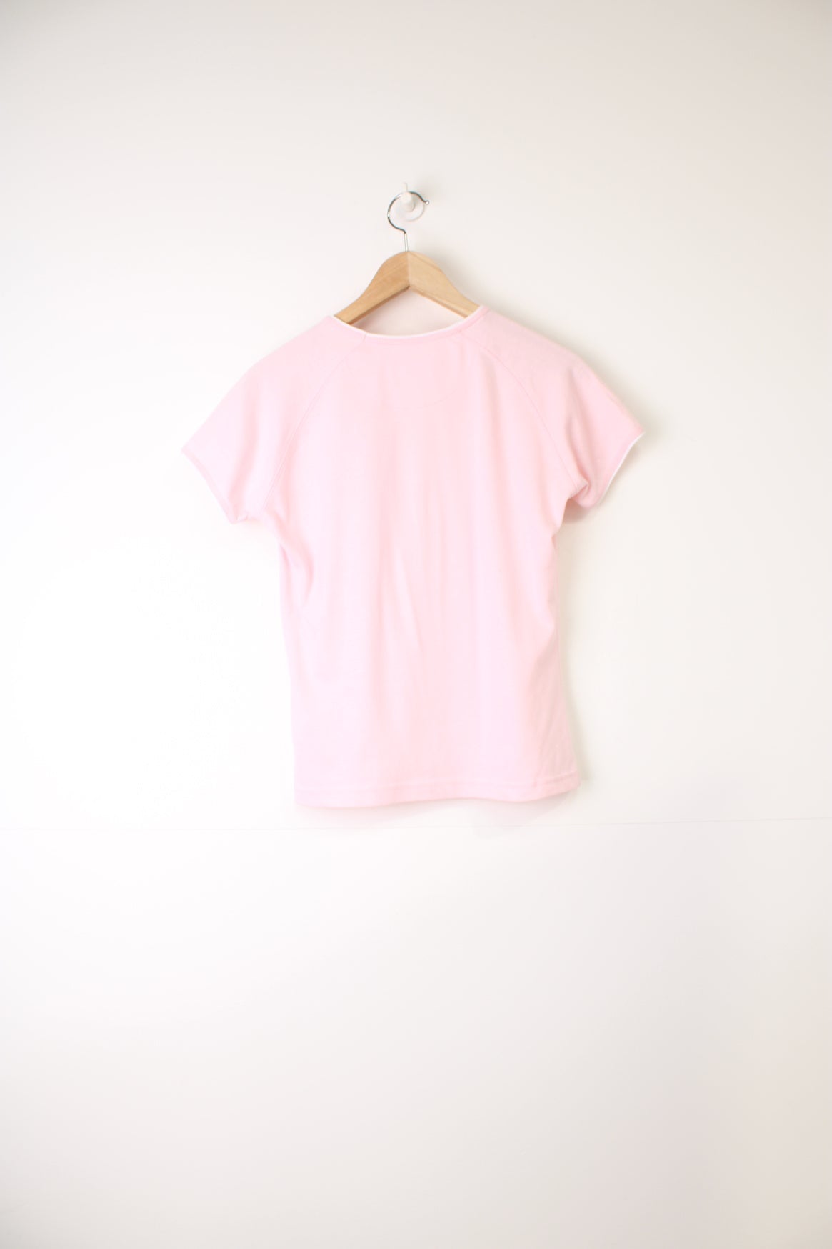 Y2K style pale pink baby tee by Reebok, features embroidered spell-out logo across the chest