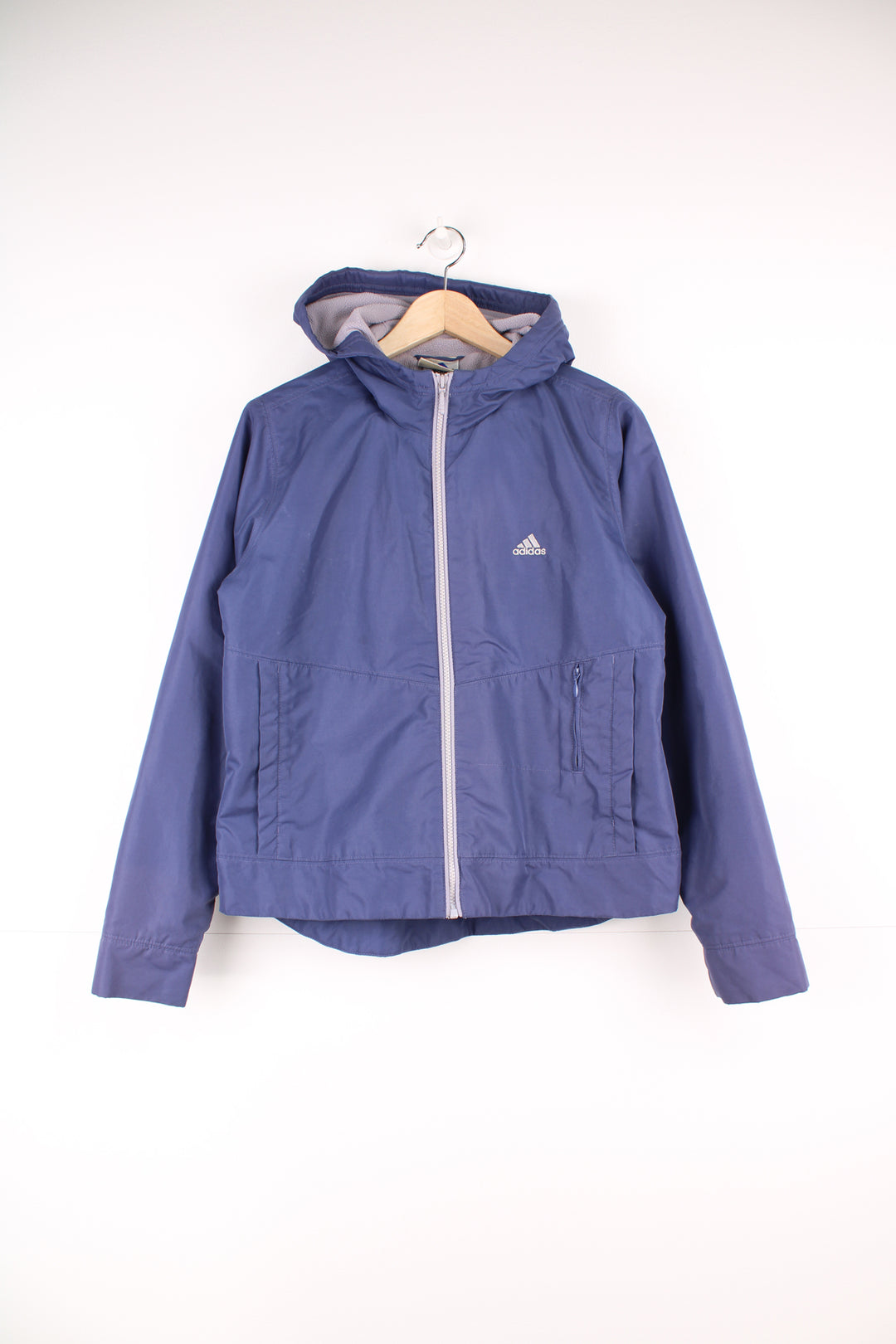 Adidas Jacket in a purple colourway, zip up with side pockets, fleece lining, hooded and has the logo embroidered on the front.