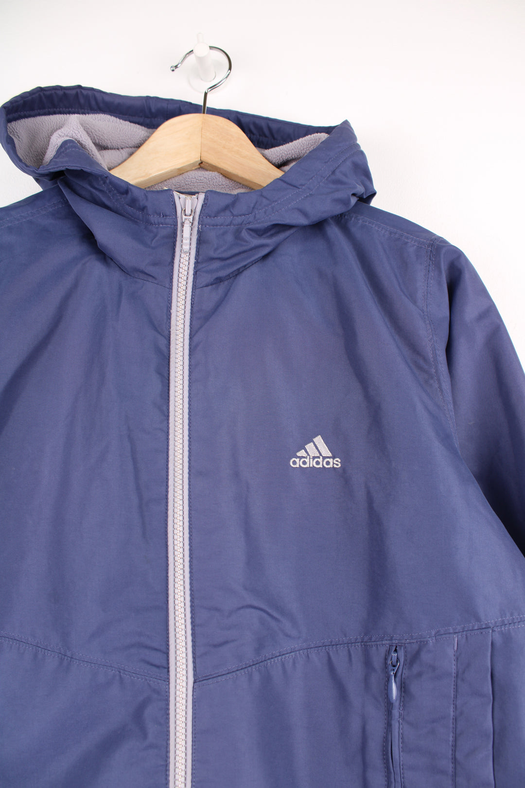 Adidas Jacket in a purple colourway, zip up with side pockets, fleece lining, hooded and has the logo embroidered on the front.