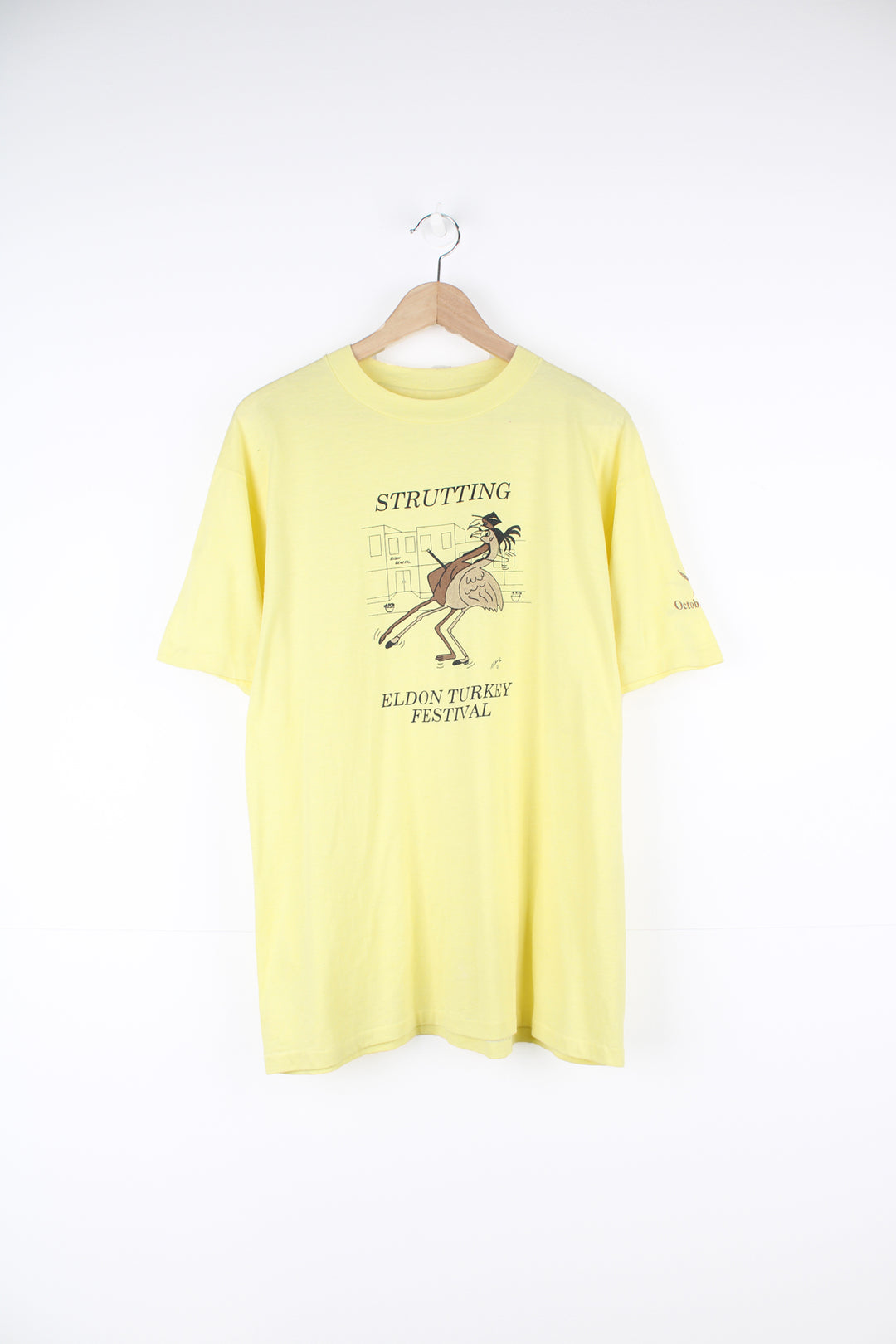 Vintage 1986 'Strutting' Eldon Turkey Festival in a pale yellow with printed graphic on the front, by Hanes