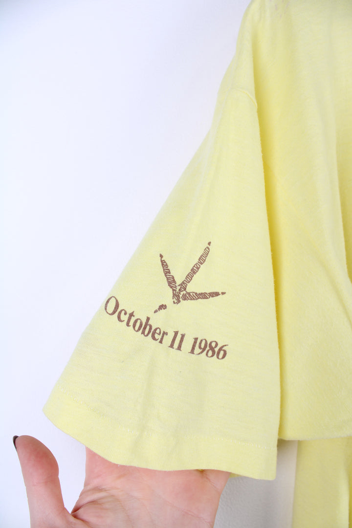 Vintage 1986 'Strutting' Eldon Turkey Festival in a pale yellow with printed graphic on the front, by Hanes