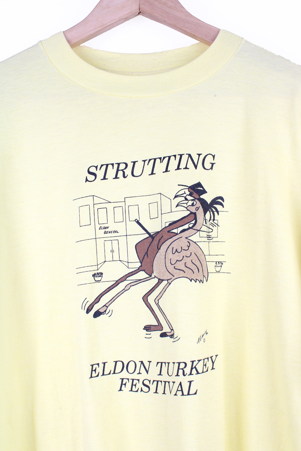 Vintage 1986 'Strutting' Eldon Turkey Festival in a pale yellow with printed graphic on the front, by Hanes