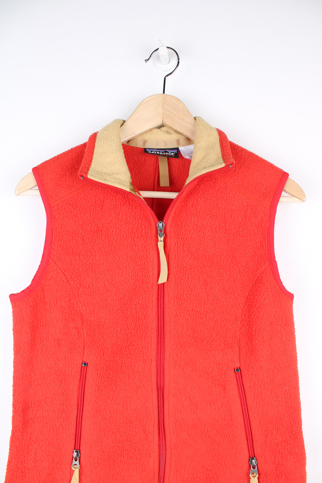 Patagonia Synchilla Fleece Gilet in a orange colourway, zip up with side pockets.