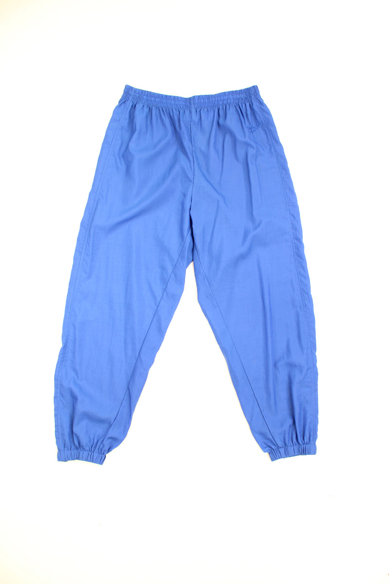 Reebok Tracksuit Bottoms in a blue colourway, adjustable waist, cuffed at the bottom and has the logo embroidered on the front.