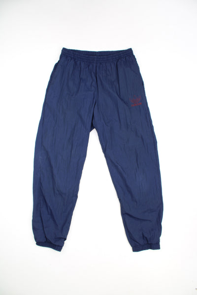 Adidas Tracksuit Bottoms in a blue colourway, adjustable waist, cuffed at the bottom and has the logo embroidered on the front.