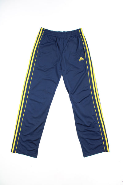 Adidas Tracksuit Bottoms in a blue and yellow colourway with the iconic three stripes going down the sides, adjustable waist, and has the logo embroidered on the front.