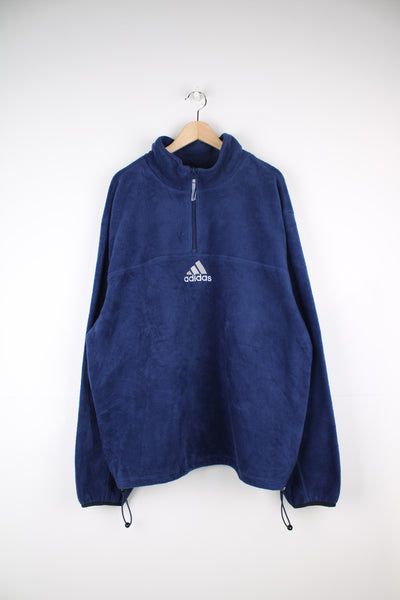 Adidas Pullover Fleece in a blue colourway, quarter zip up, adjustable waist line, and has the logo embroidered on the front.