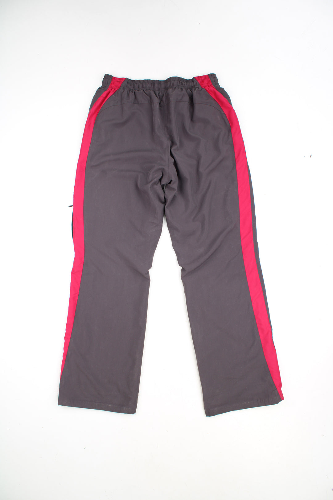 Reebok Tracksuit Bottoms in a grey and pink colourway with stripes going down the sides, adjustable waist, cargo style pocket, and has the logo embroidered on the front.