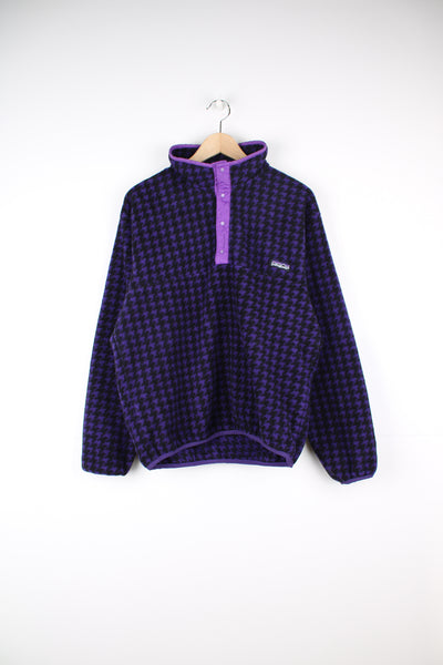 Patagonia Fleece in a purple and black patterned colourway, button up and has the logo embroidered on the front.