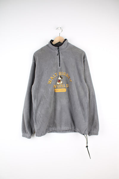 Disney World Fleece in a grey colourway, quarter zip with side pockets, and has Mickey Mouse and spell out embroidered on the front.