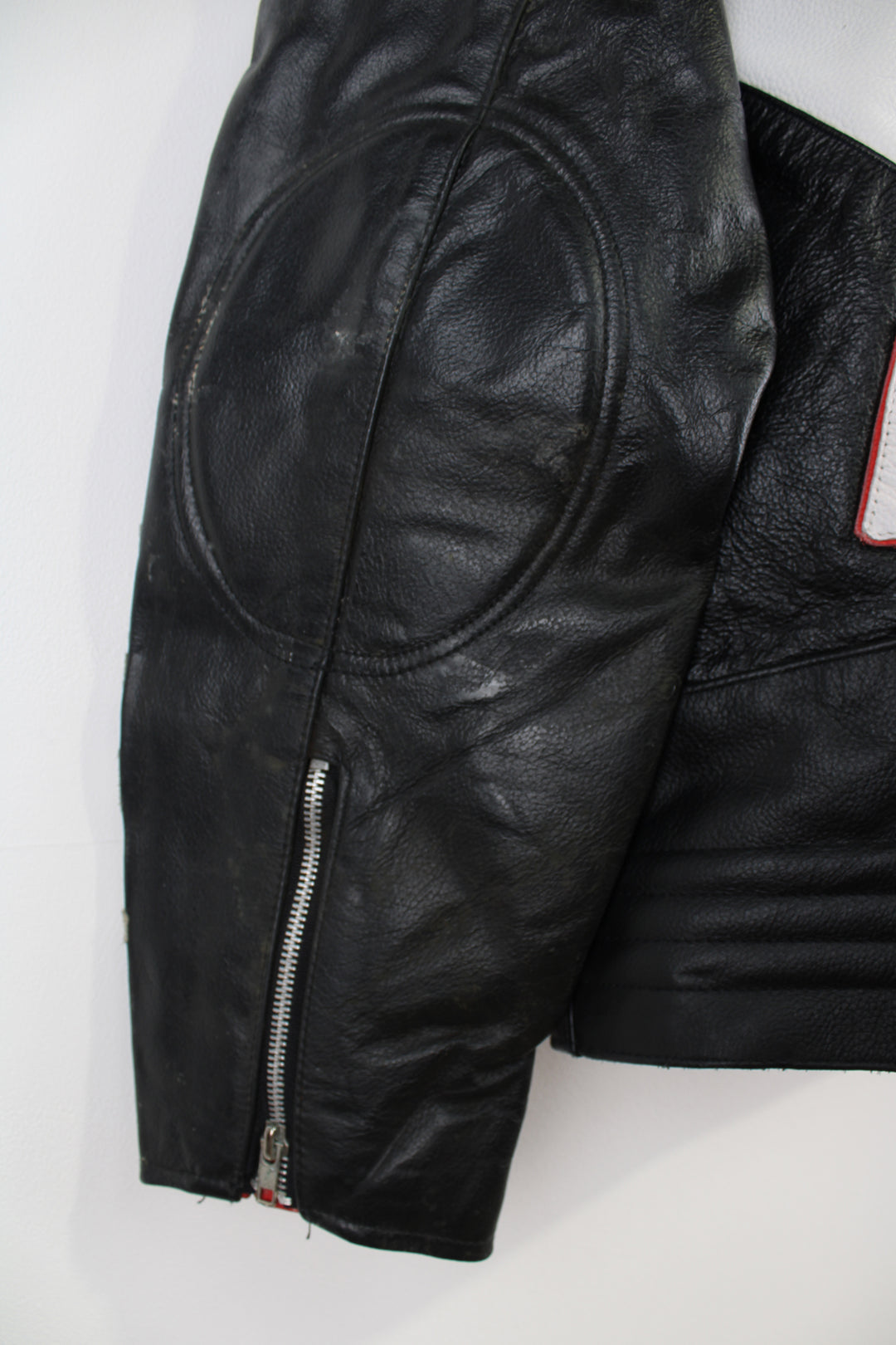 Vintage Honda Repsol zip through leather motorcycle racing jacket in red and black, features embroidered sponsor badges through out