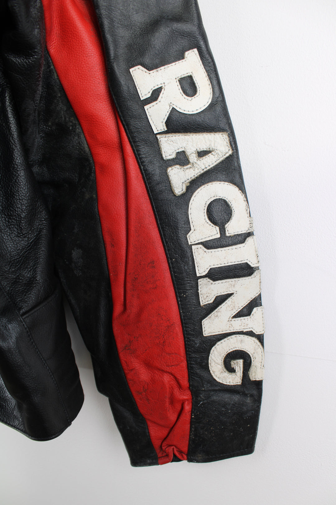 Vintage Honda Repsol zip through leather motorcycle racing jacket in red and black, features embroidered sponsor badges through out