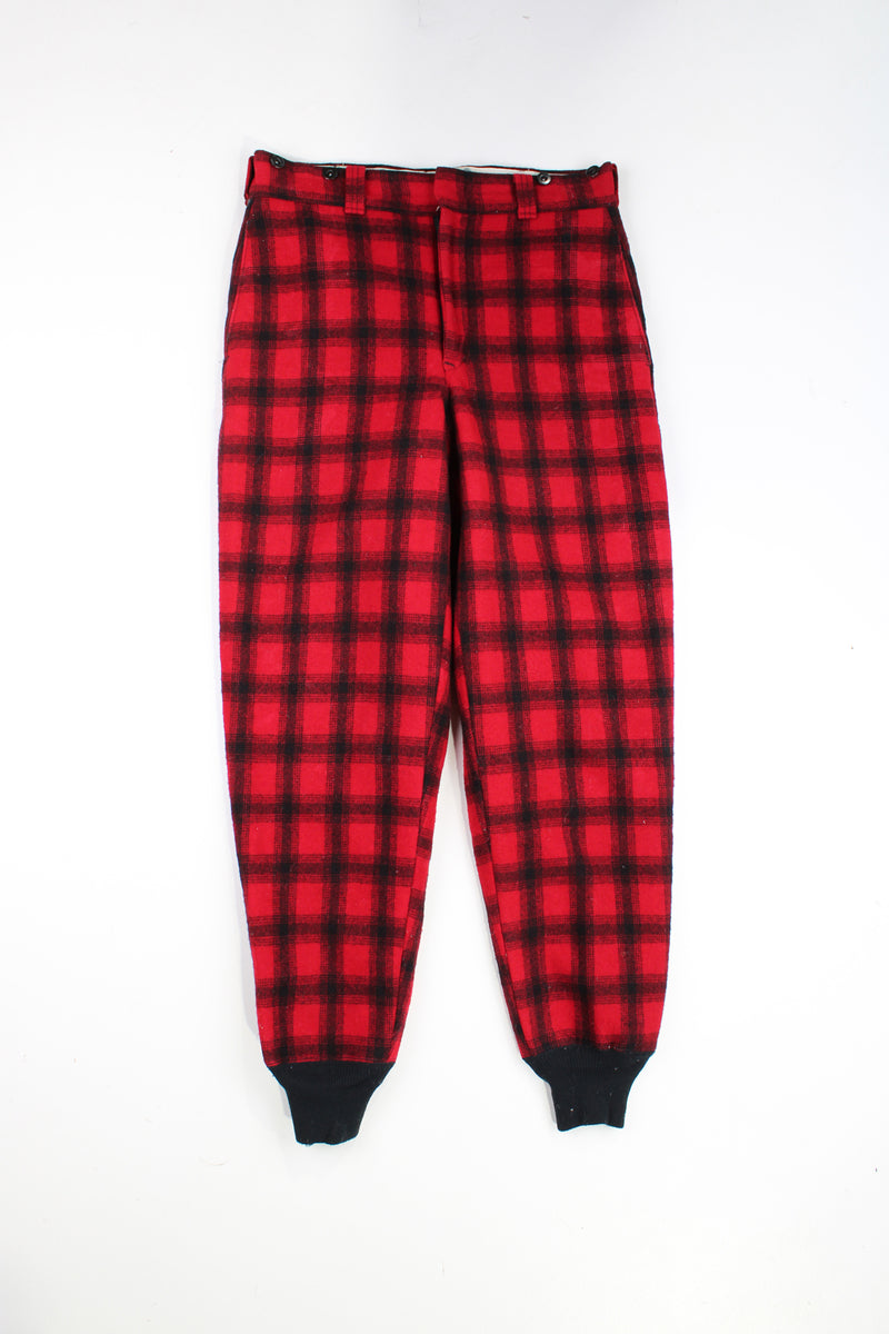  Vintage 60's Woolrich hunting trousers. Red check wool trousers with elasticated cuffs and quilted lining.   good condition - one small mark on the leg (see photos)  Size in Label:  Mens 32 (M)  Our Measurements:  Waist: 33 inches  Leg Inseam: 32 inches