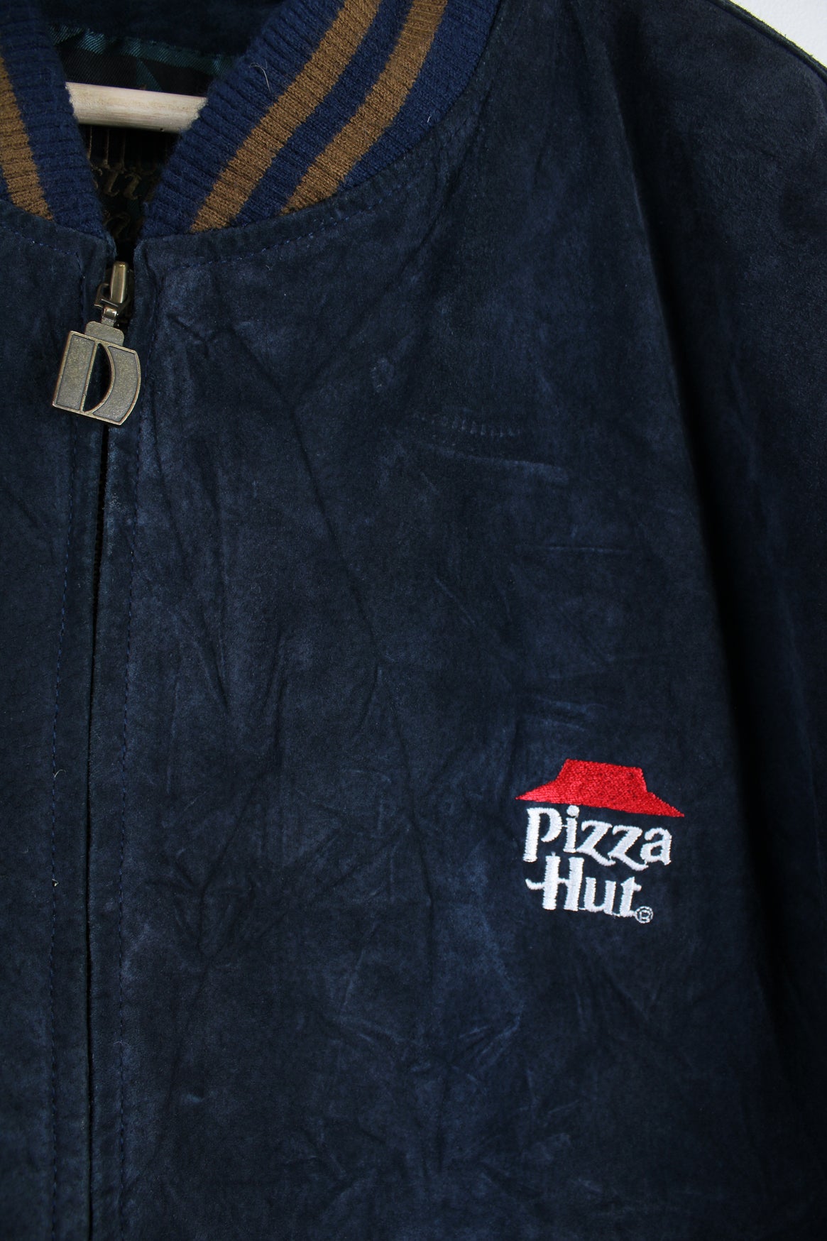 Vintage Pizza Hut Leather Varsity Jacket in a blue and brown colourway, nylon lining, zip up, and has embroidered logo on the chest.