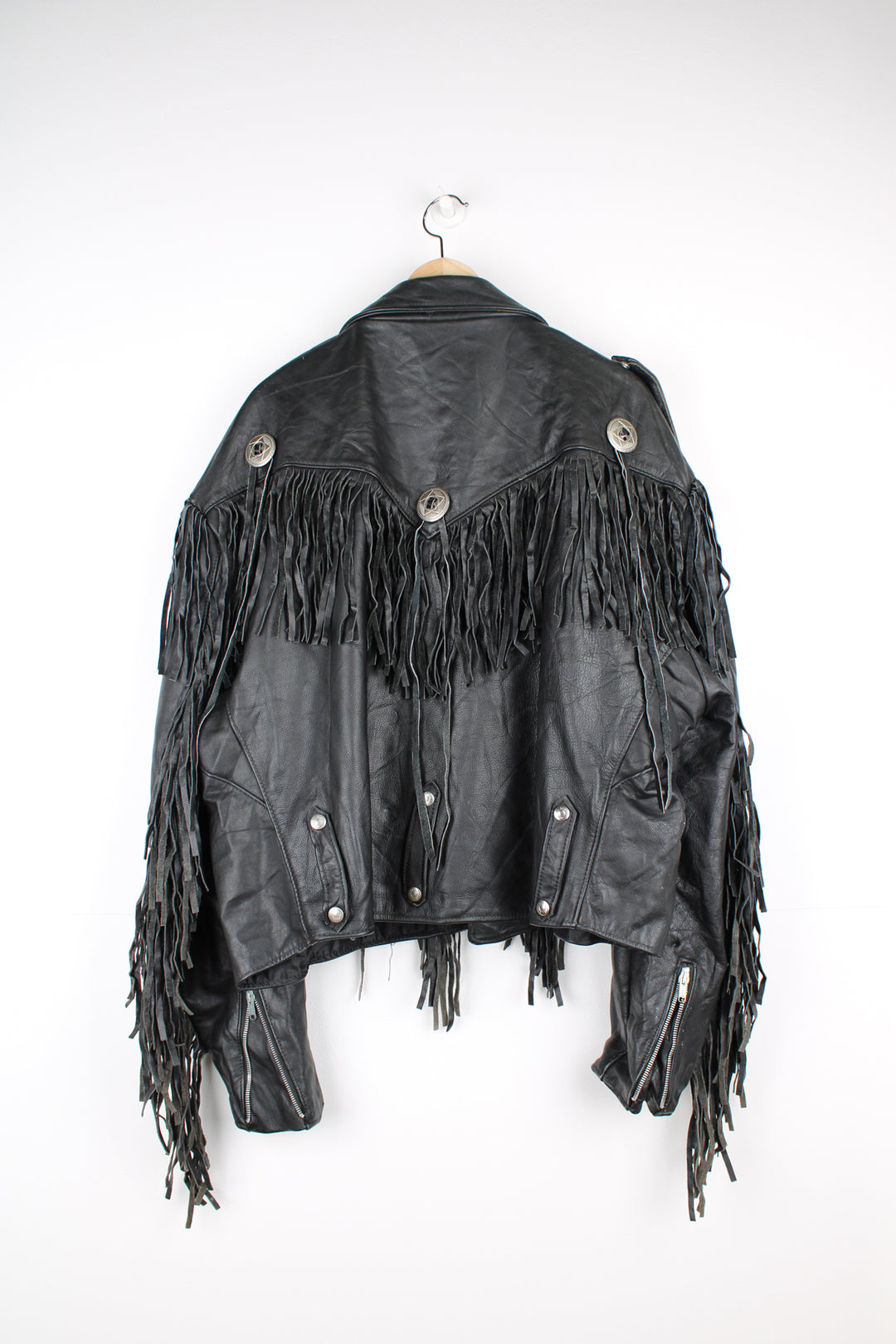 Vintage black leather zip through biker jacket with fringe by Schott features chunky hardware and silvery western style conch buttons 