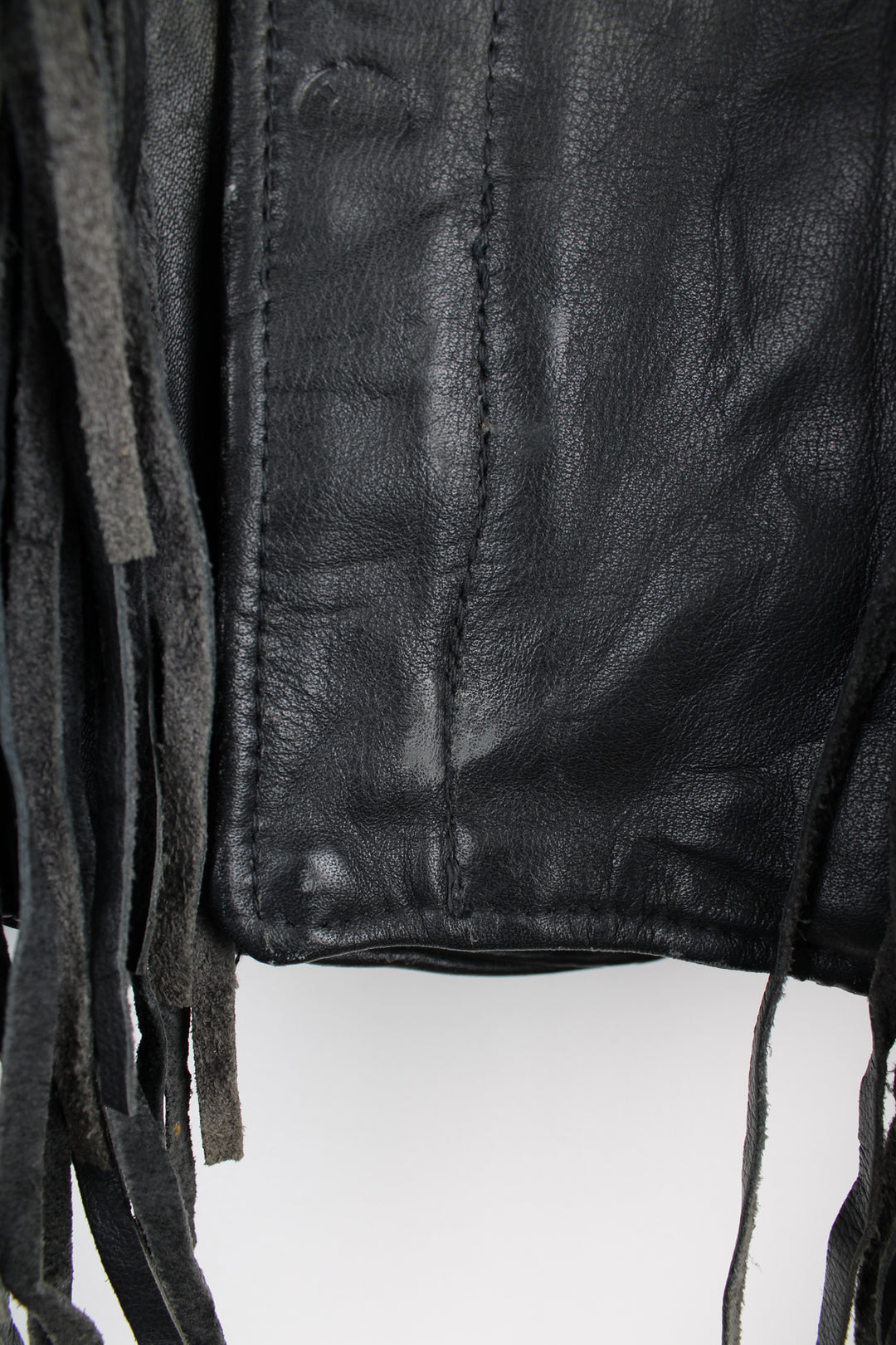 Vintage black leather zip through biker jacket with fringe by Schott features chunky hardware and silvery western style conch buttons 