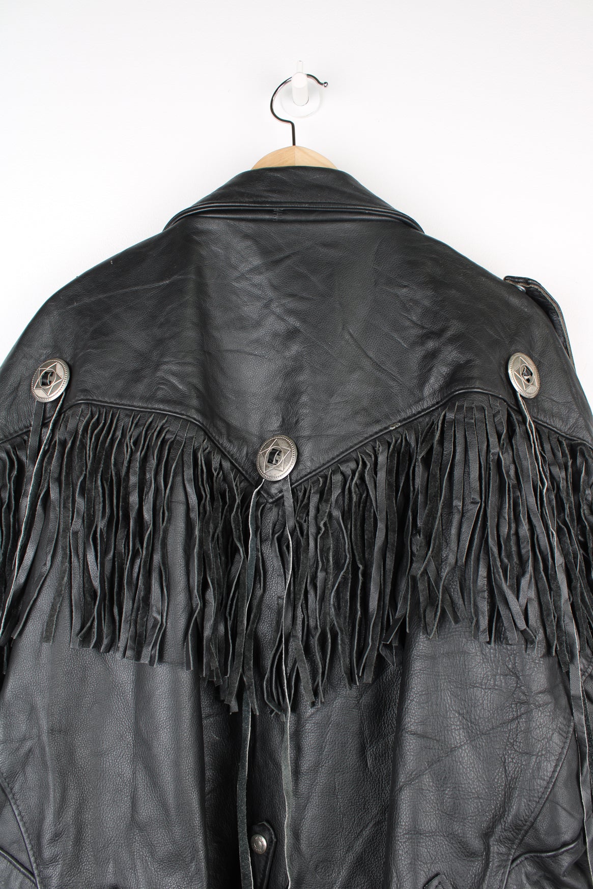 Vintage black leather zip through biker jacket with fringe by Schott features chunky hardware and silvery western style conch buttons 