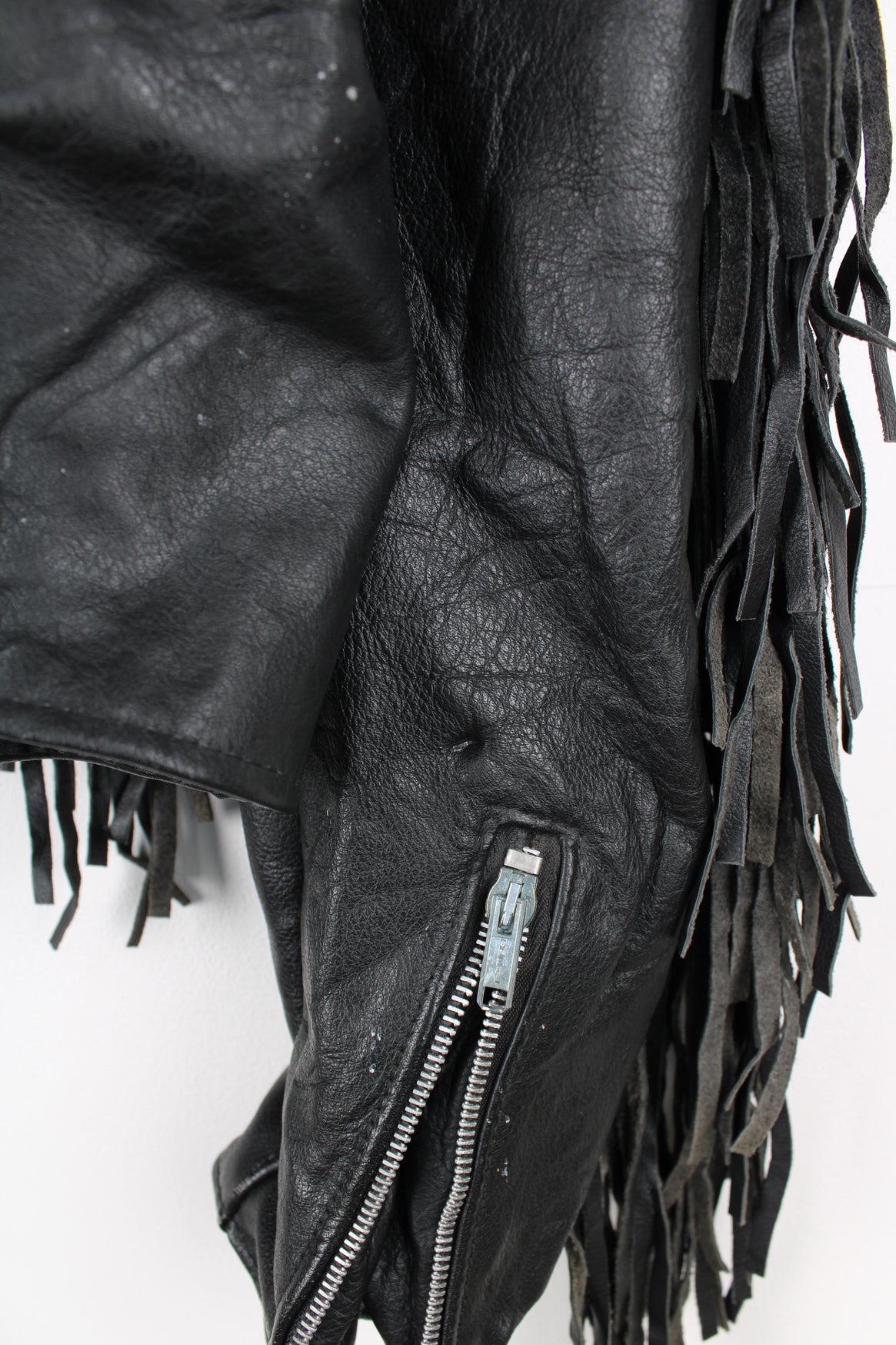 Vintage black leather zip through biker jacket with fringe by Schott features chunky hardware and silvery western style conch buttons 