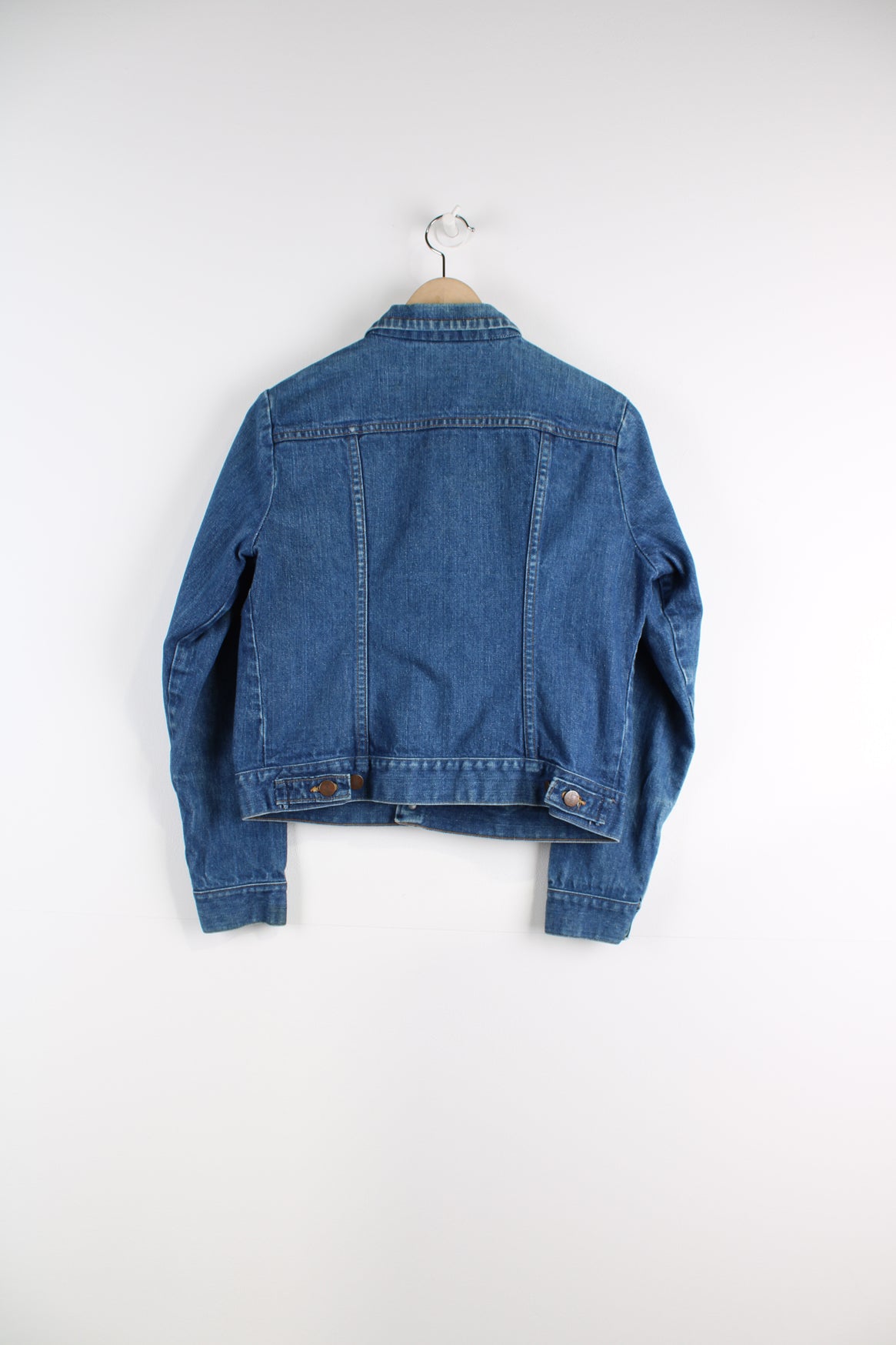 Vintage Wrangler Denim Jacket in a blue colourway, button up, double chest pockets, and has logo embroidered on the chest.