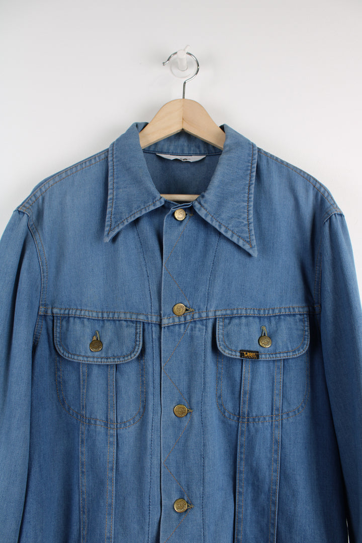 Vintage Lee Denim Jacket in a blue colourway, button up, double chest pockets, and has logo embroidered on the chest.