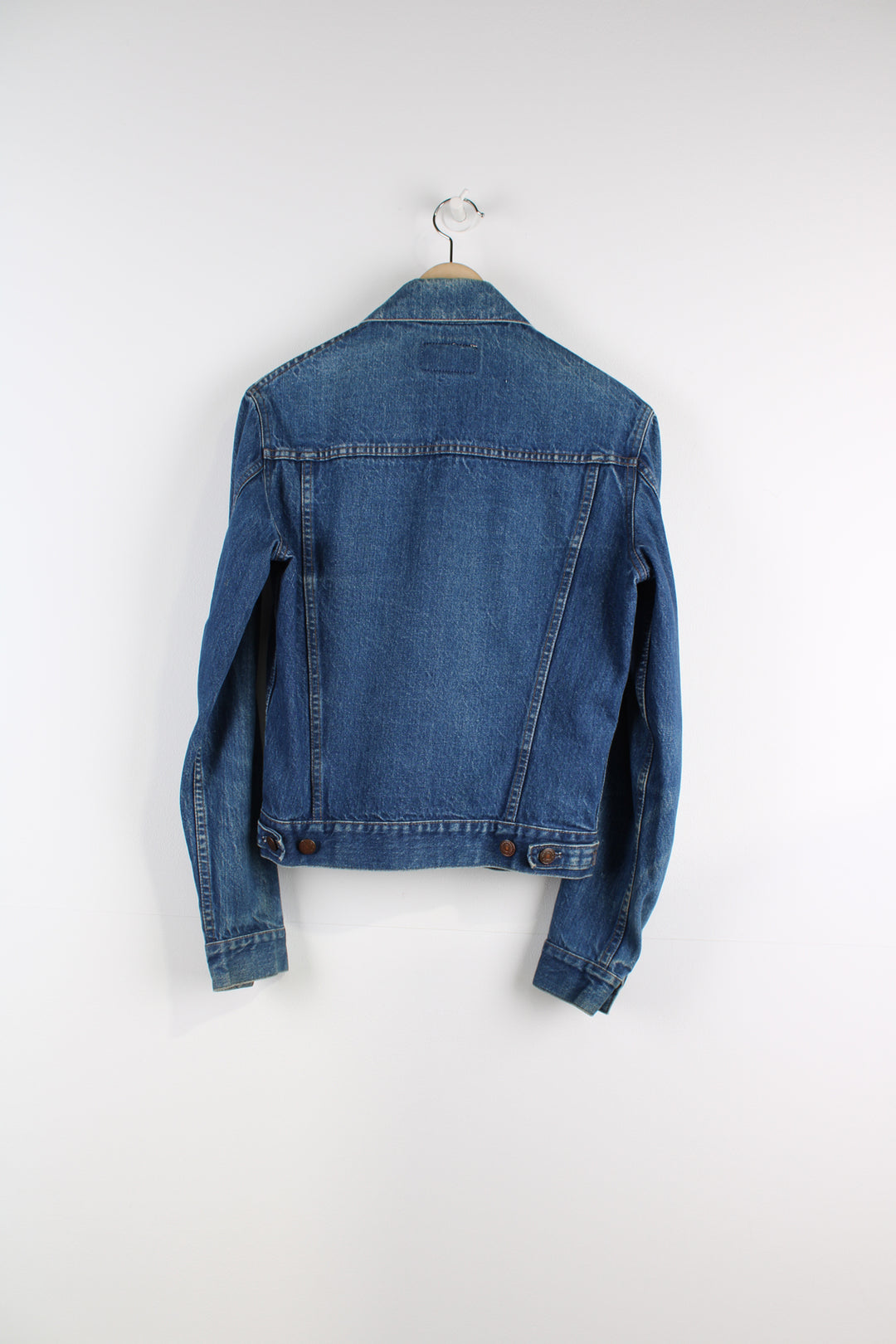 Vintage Levi's Denim Jacket in a blue colourway, button up, double chest pockets, and has orange tab logo embroidered on the chest.