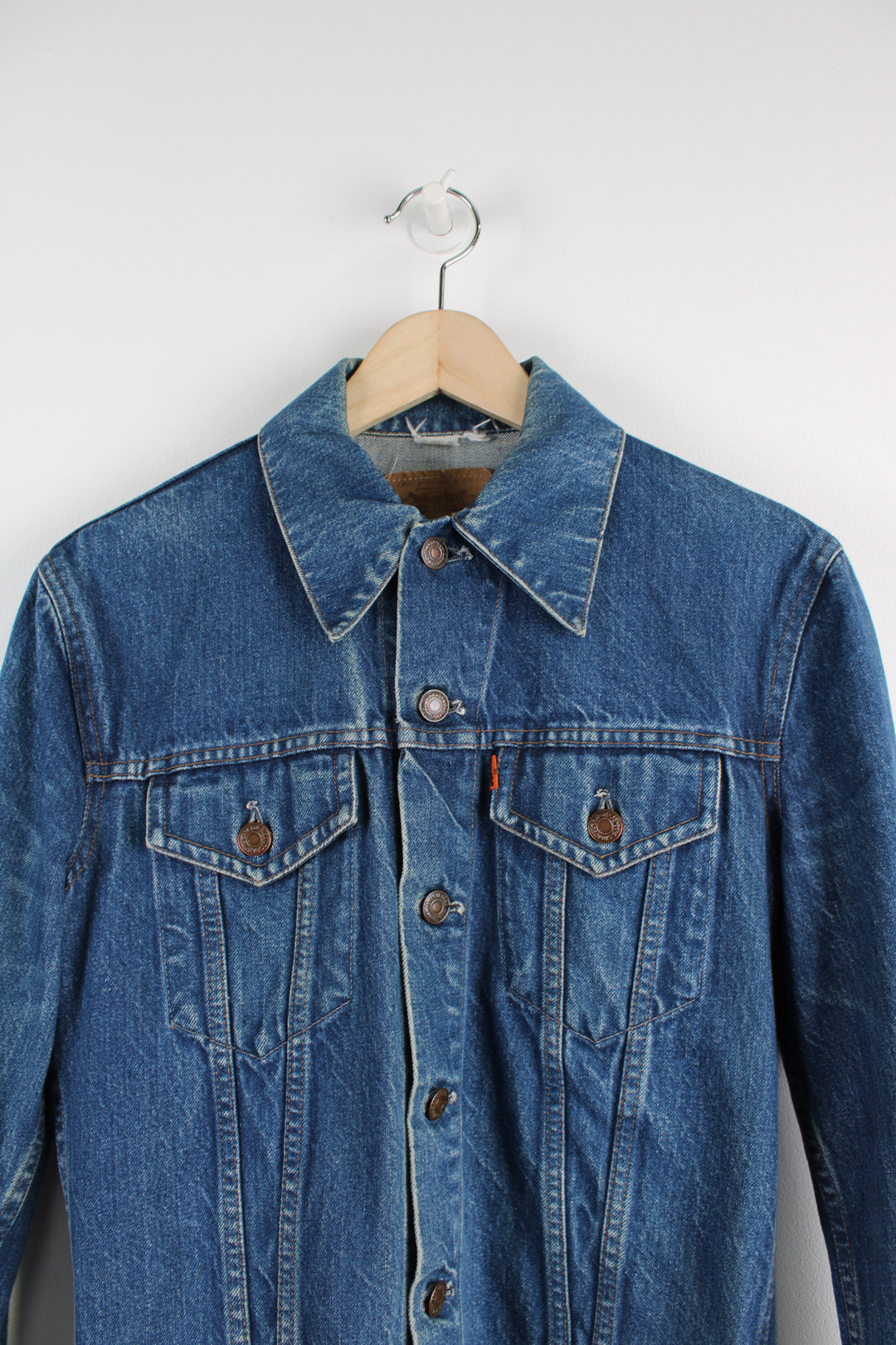 Vintage Levi's Denim Jacket in a blue colourway, button up, double chest pockets, and has orange tab logo embroidered on the chest.