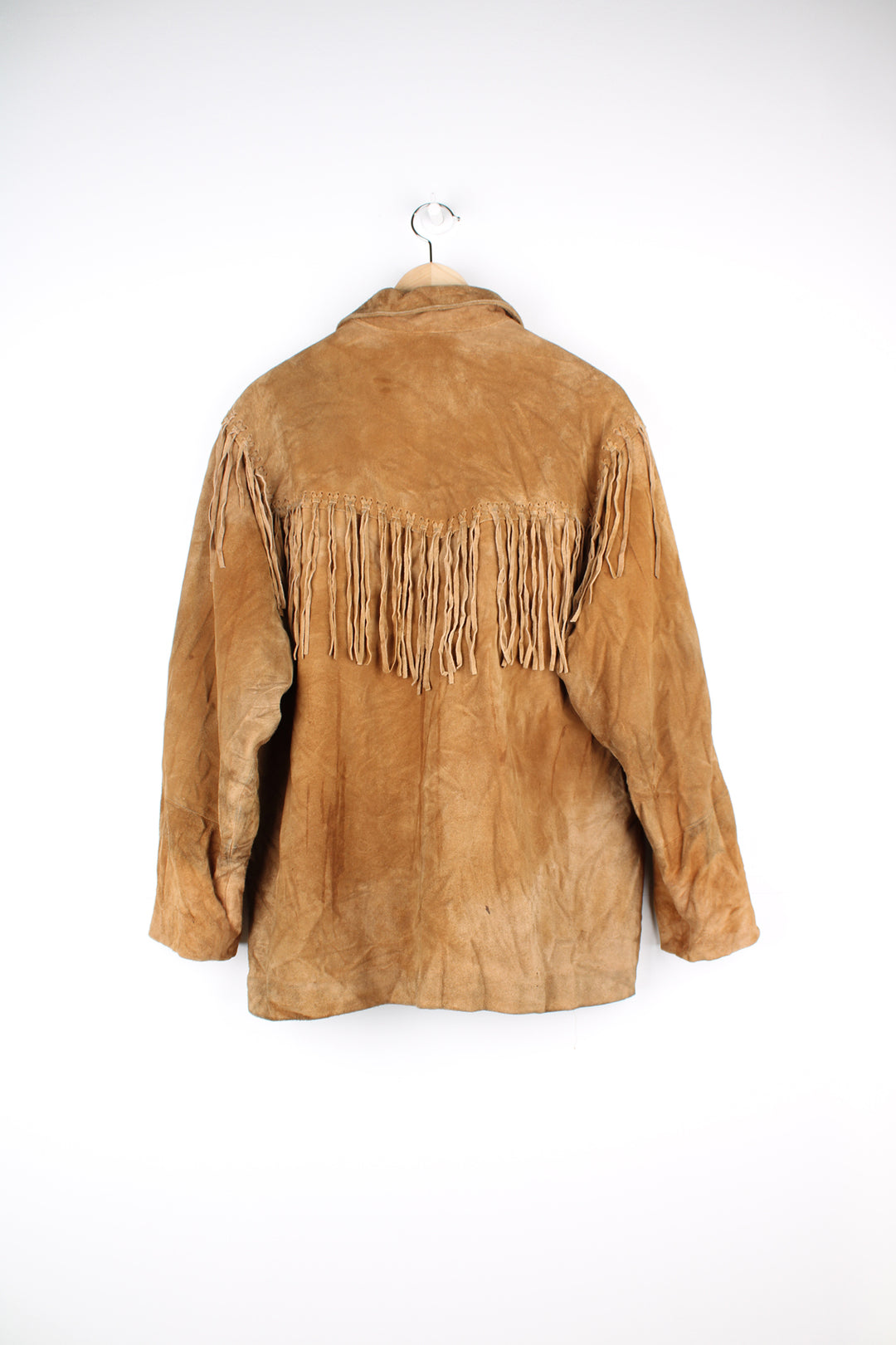 Vintage 90's DKNY fringe jacket. Tan suede jacket with fringe and whip stitch detail. The jacket is fully lined and closes with wooden toggle style buttons down the front. Fair condition - The jacket is discoloured in places and is missing some tassels on the shoulder and pocket. Size in Label: Womens L 12 - 14 