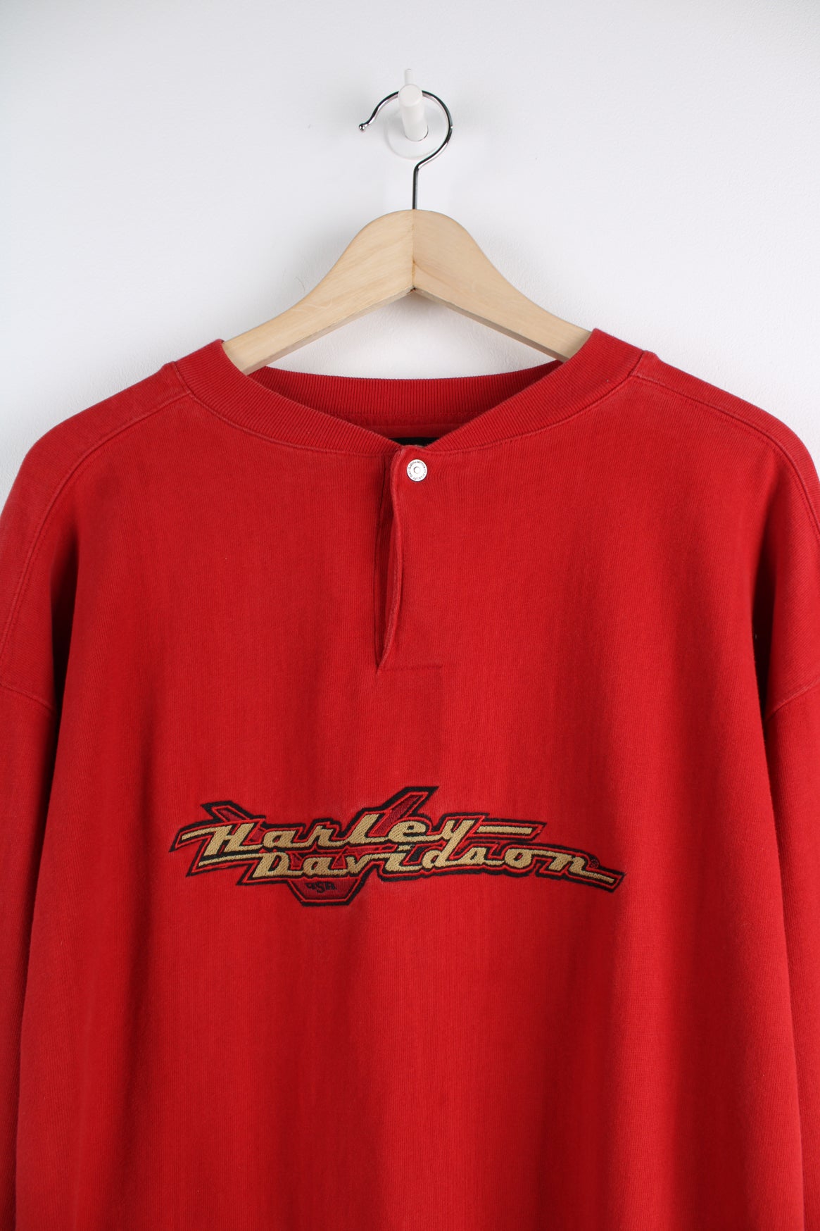 Harley Davidson Long Sleeve T-Shirt in a red colourway, quarter button up, and has the logo embroidered across the chest.