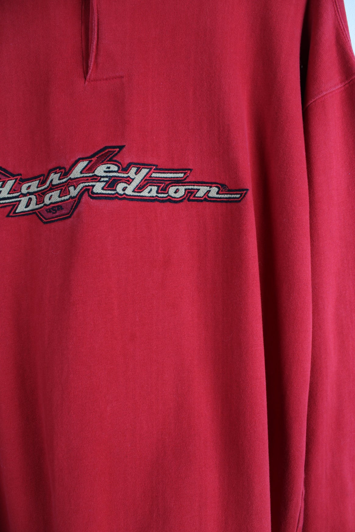 Harley Davidson Long Sleeve T-Shirt in a red colourway, quarter button up, and has the logo embroidered across the chest.