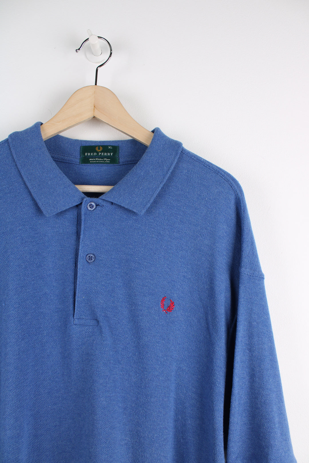 Fred Perry Polo Shirt in a blue and red colourway, quarter button up, and has the logo embroidered on the chest.