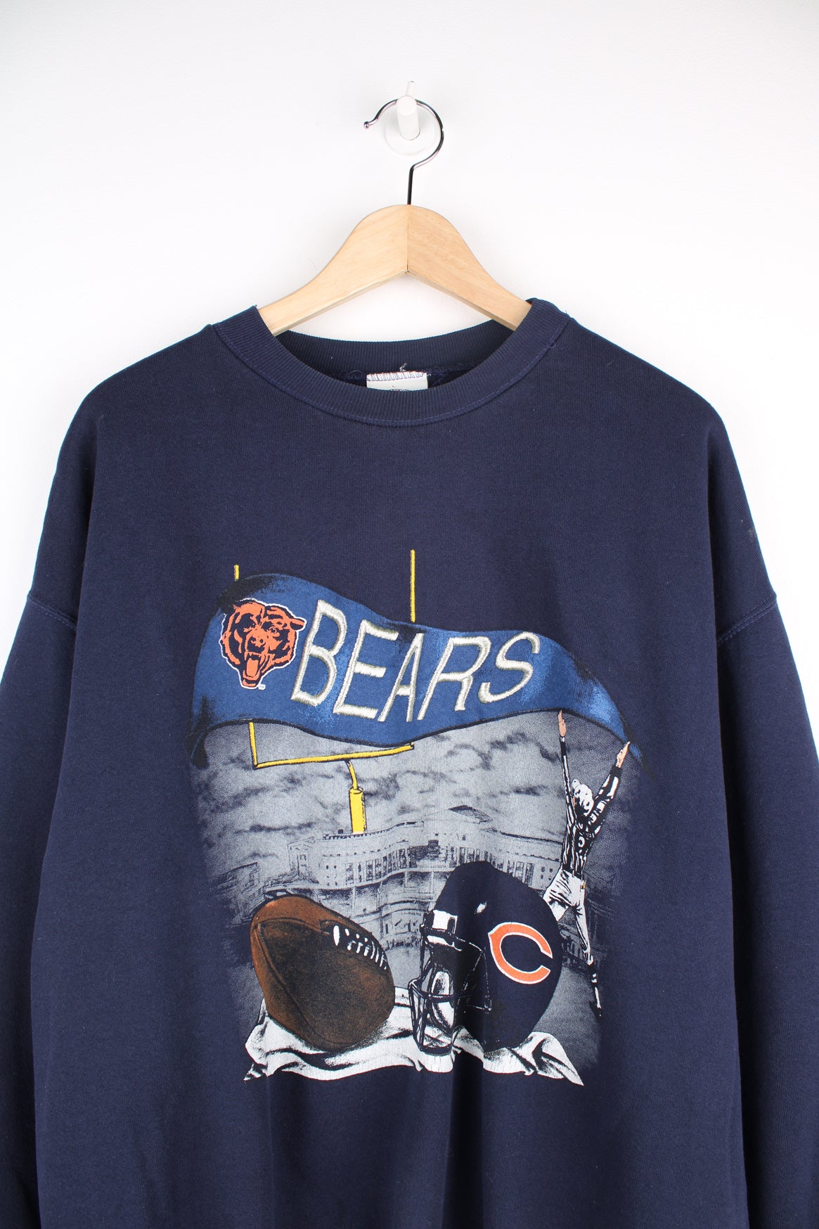 Vintage Chicago Bears NFL Sweatshirt in a blue colourway, Nutmeg tag, and has big embroidered logo spell out alongside printed football graphic.