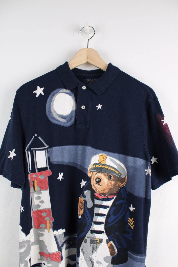 Ralph Lauren Nautical Bear Polo Shirt in a blue colourway with all over sailor bear print graphic on the front and back, 1/4 button up.