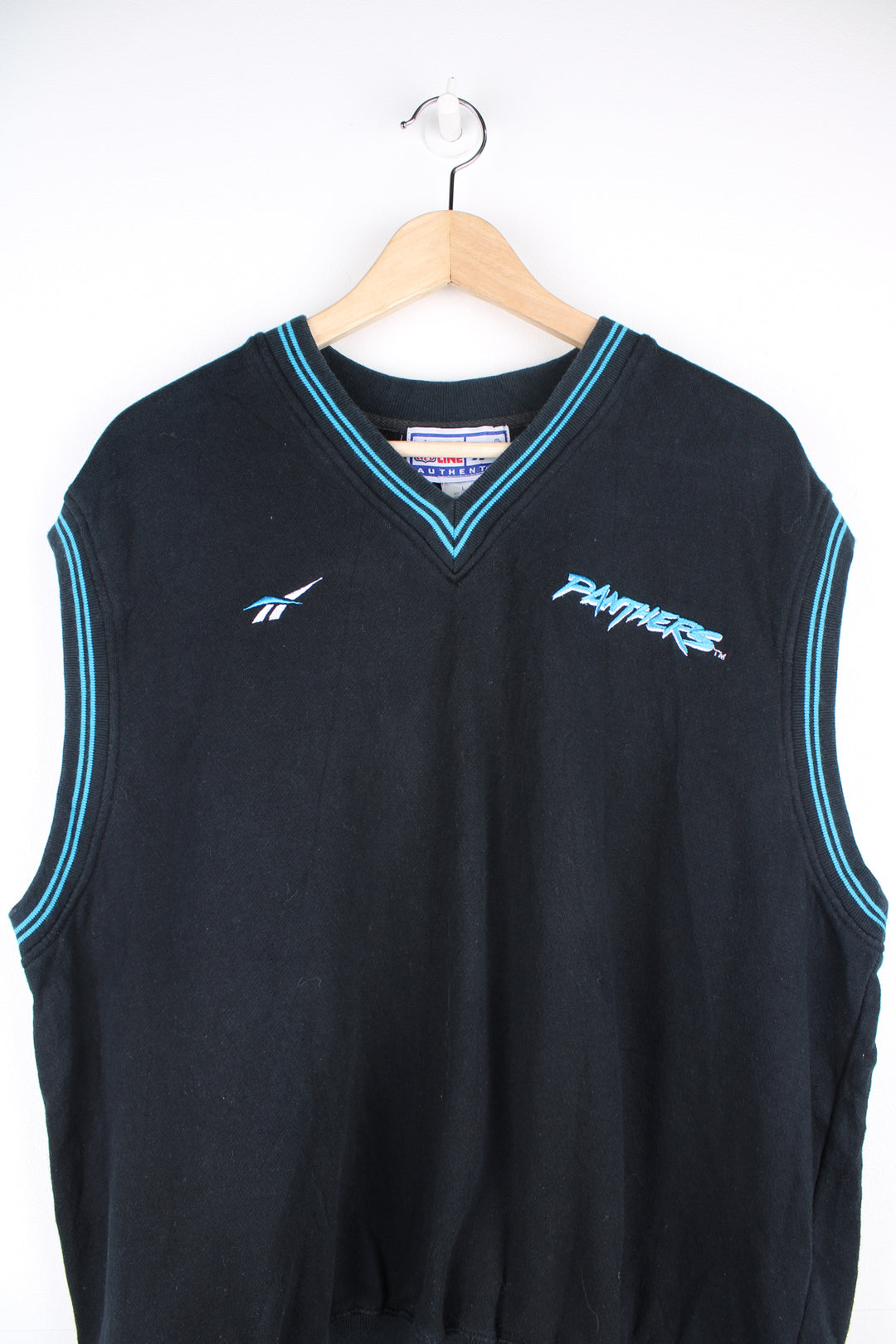 Reebok NFL Pro Line, Carolina Panthers Sweater Vest in a black and blue colourway, v neck, and has the logos embroidered on the front and back.