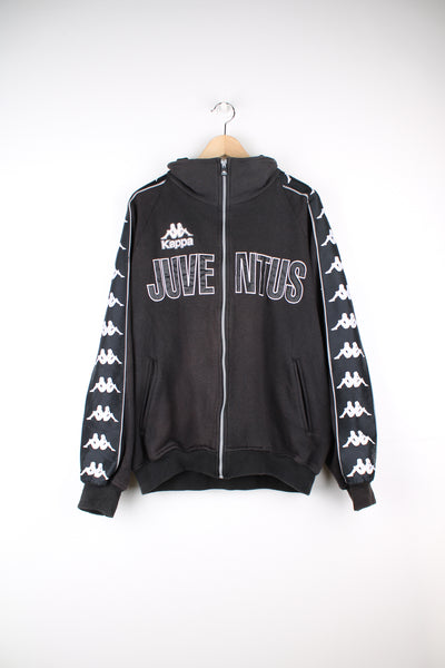 Kappa Juventus Track Jacket in the black and white colourway, zip up sweatshirt, side pockets, Kappa logo going down the sleeves, and has the spell out embroidered on the front and back.