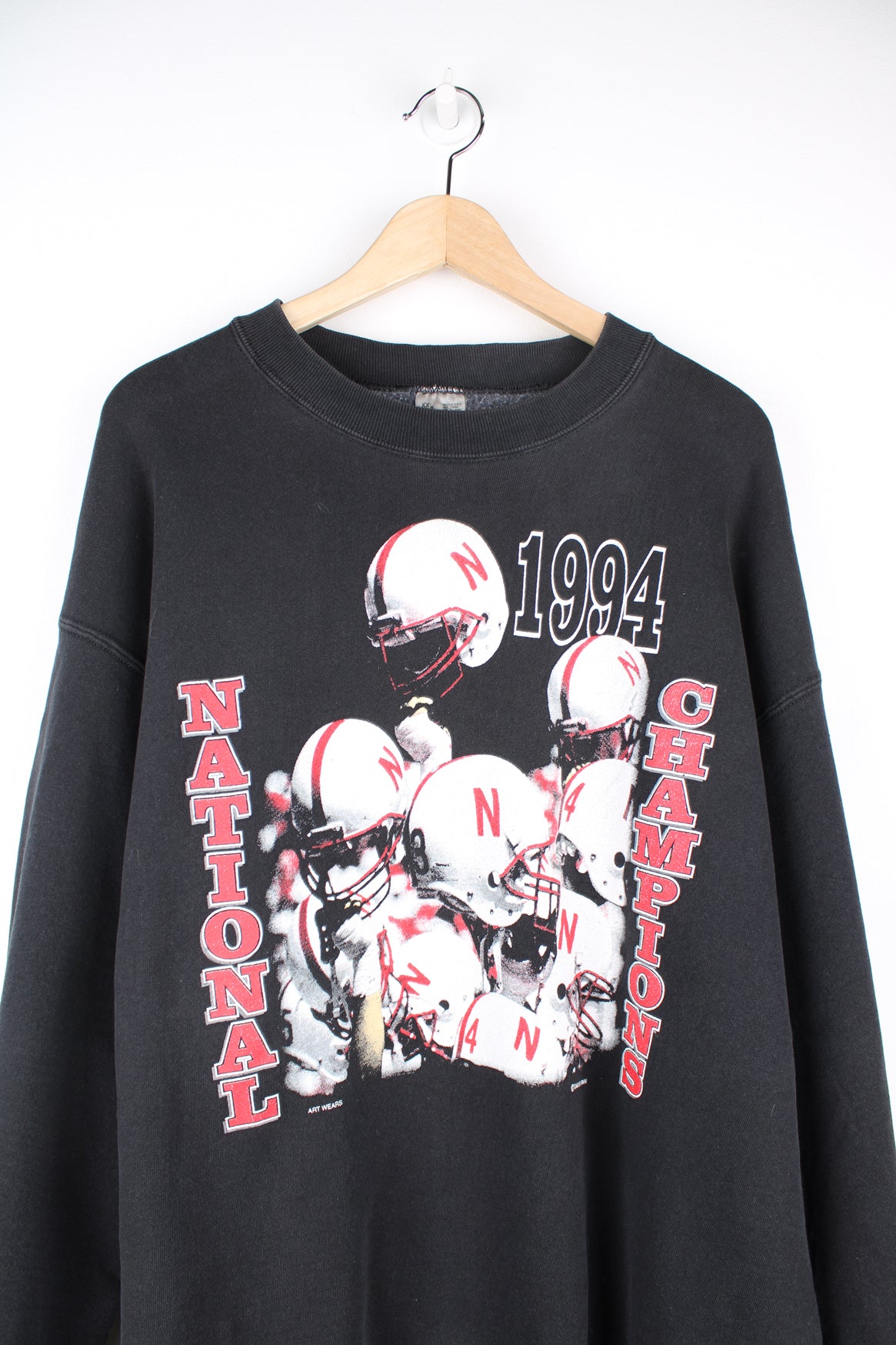 University of Nebraska Cornhuskers Football Team 1994 Champions Sweatshirt in a black colourway, and has the team champions graphic printed on the front.