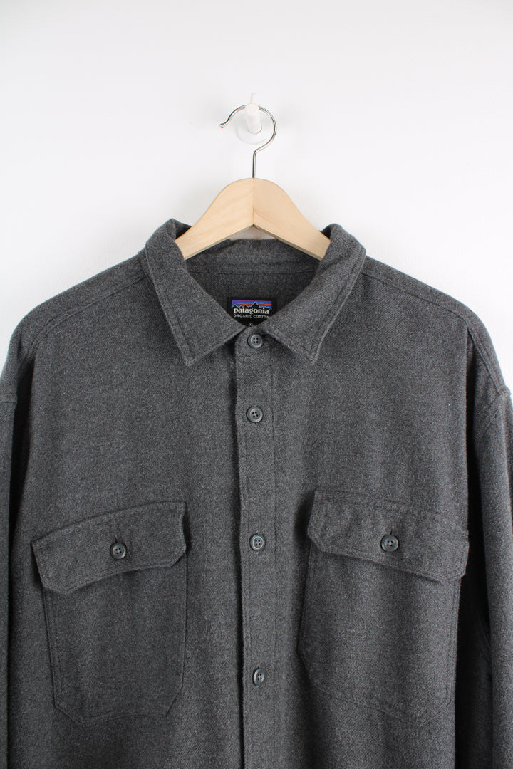 Patagonia Shirt in a grey colourway, button up, double chest pockets, and logo embroidered on the side.