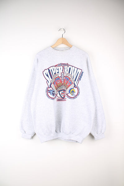 Vintage 2000 Super Bowl Titans vs Rams Sweatshirt in a grey colourway, and has the logos and spell out printed on the front.