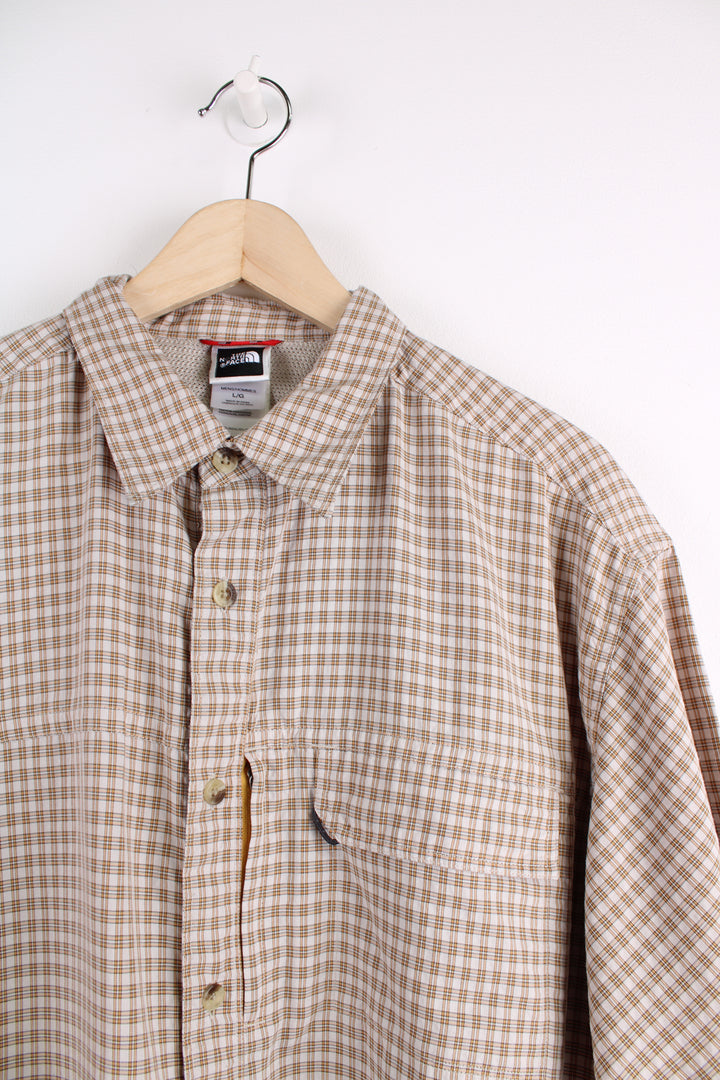 The North Face Short Sleeve Plaid Shirt in a tan and orange colourway, button up with chest pockets, and logo embroidered on the side.