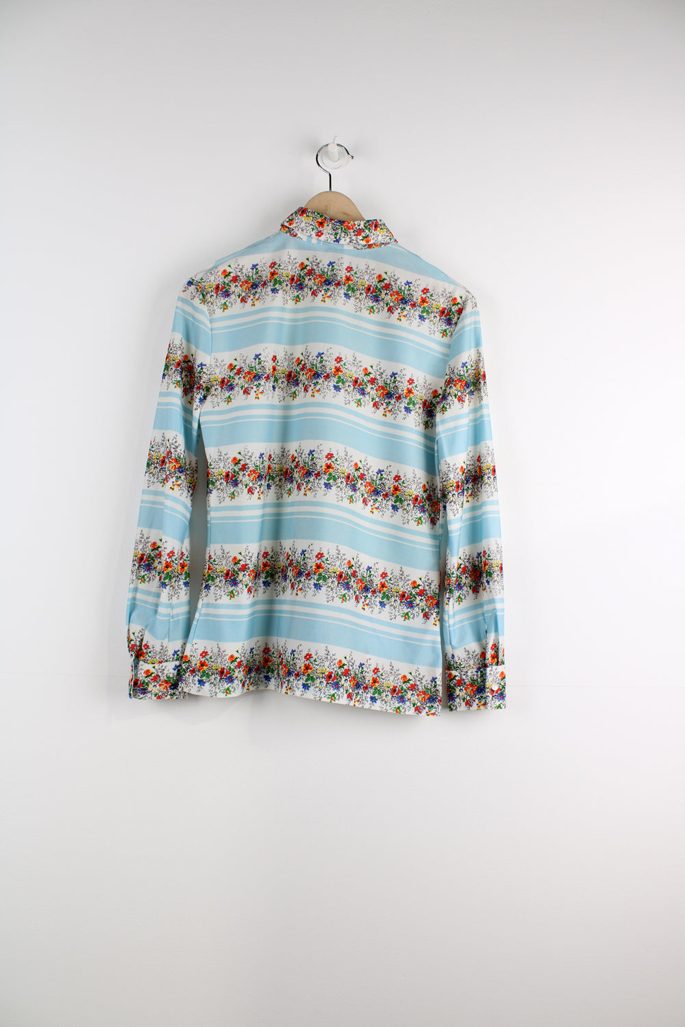 Vintage 70's Loubella Patterned Blouse in a white and blue striped colourway with multicoloured flowers printed across, button up, and has a dagger collar.