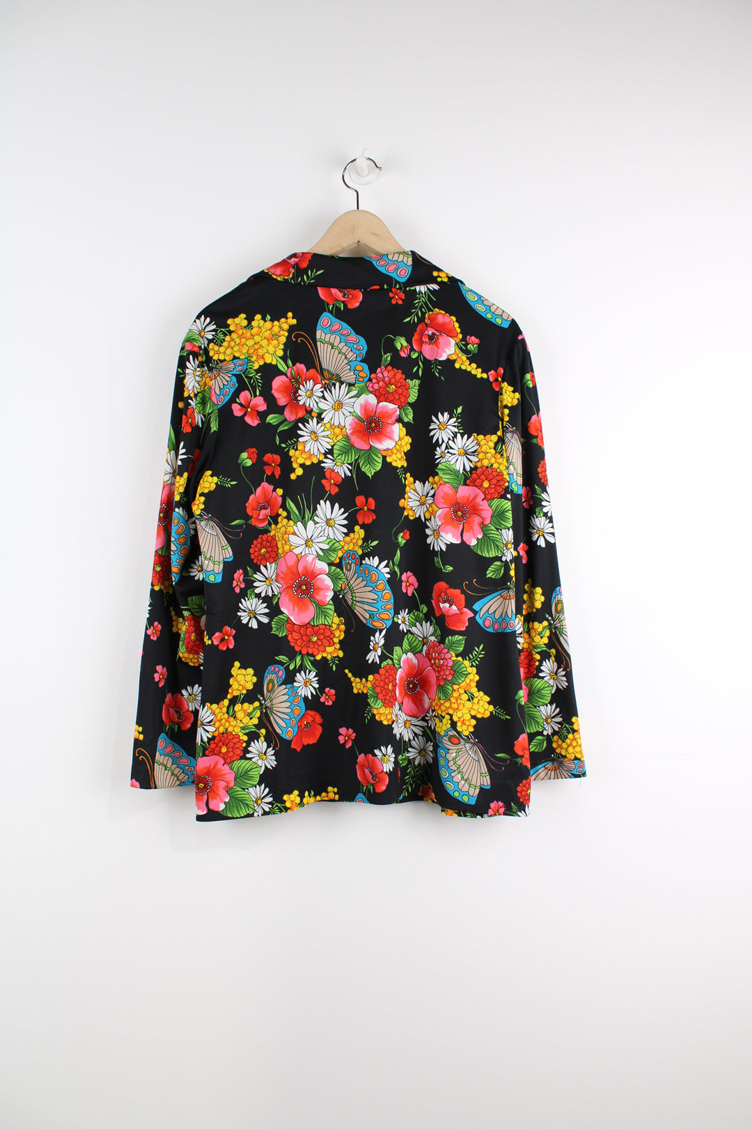 Vintage 70's Patterned Blouse in a black colourway with multicoloured flowers printed all over, button up, and has a camp collar.