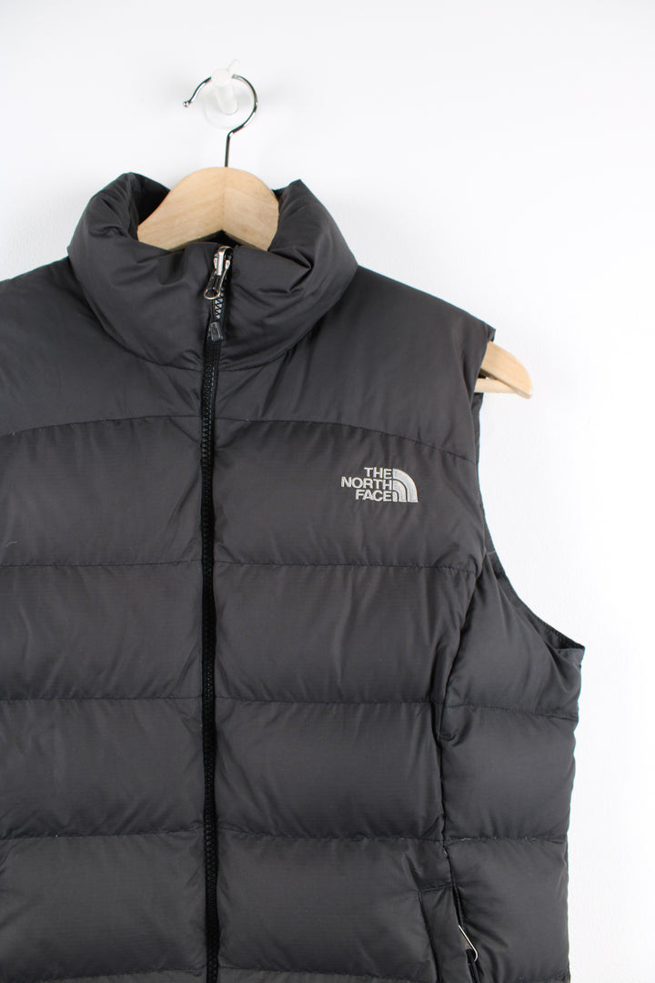 Women's The North Face 700 black puffer gilet with kangaroo pockets, draw string hem and embroidered logo on the front and back