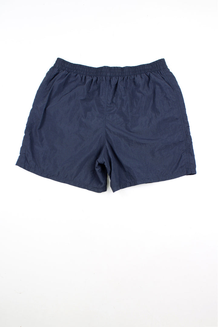 Navy blue Emporio Armani swim shorts with elasticated waistband and lace up tie at the front. Features embroidered logo on the leg.