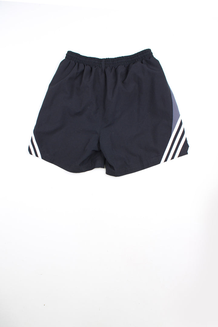 00's black Adidas sports shorts with elasticated waist and drawstring tie. Features three stripe detail down the side of the leg and embroidered logo on the front.