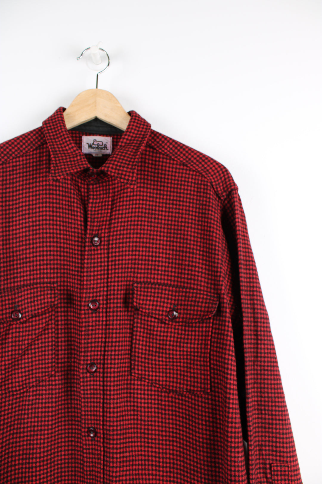 Vintage Woolrich red and black plaid button up shirt with two chest pockets.